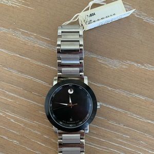 Mens stainless steel authentic Movado watch. Extra clasp for larger wrist.